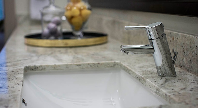 a bathroom sink with a faucet and a marble counter top at The Live Oak at  Branch