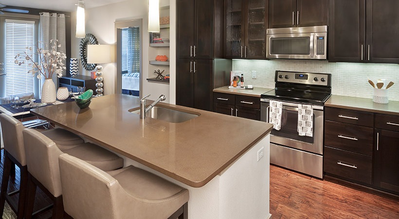 a kitchen with a large island and stainless steel appliances at The Live Oak at  Branch