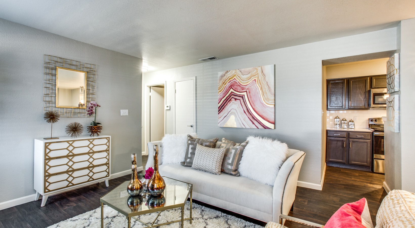 a living room with a couch, coffee table and a television at The Maxwell