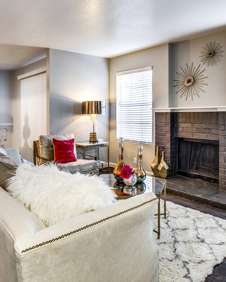 a living room with a fireplace and a couch at The Maxwell