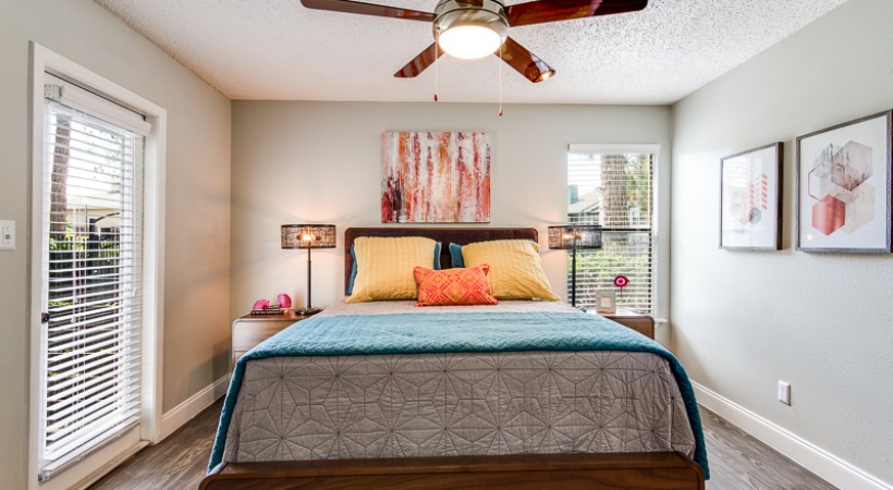 a bedroom with a ceiling fan and a bed at The Lorenzo