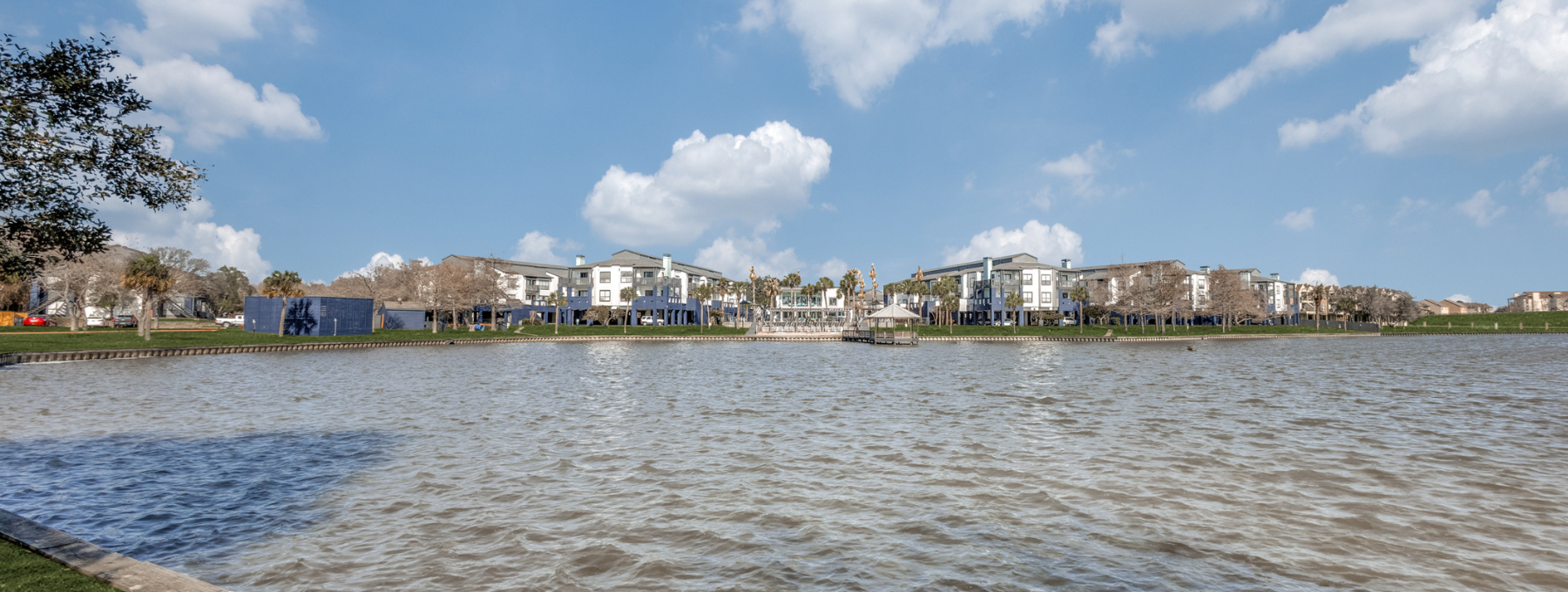a large body of water with houses on the shore at The Pearce on  Lake