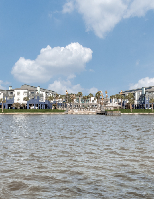 a large body of water with houses on the shore at The Pearce on  Lake