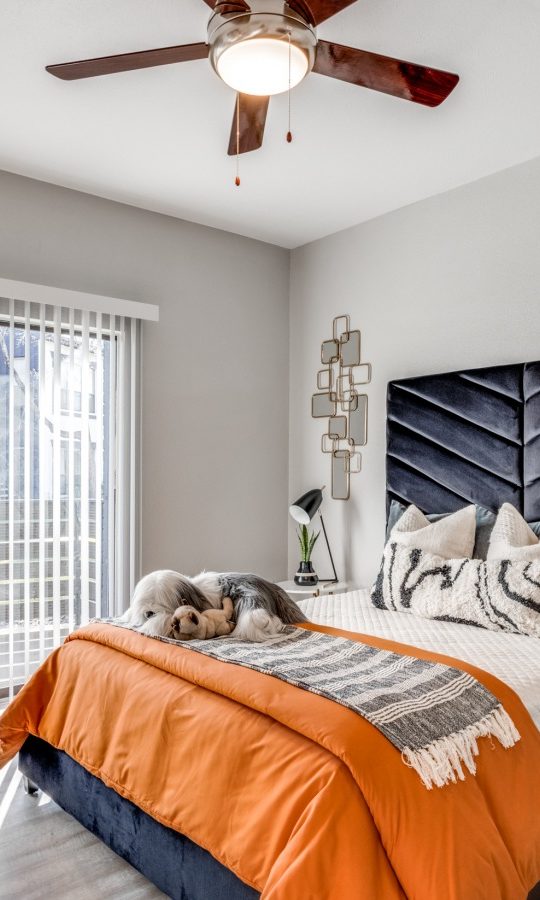 a bedroom with a bed, a ceiling fan and a large window at The Pearce on  Lake