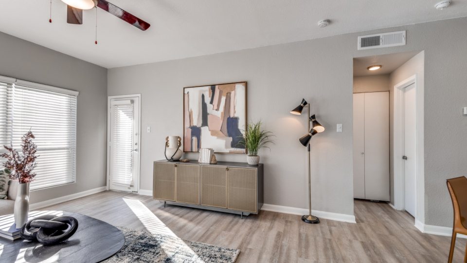 a living room with hardwood floors and a large window at The Pearce on  Lake