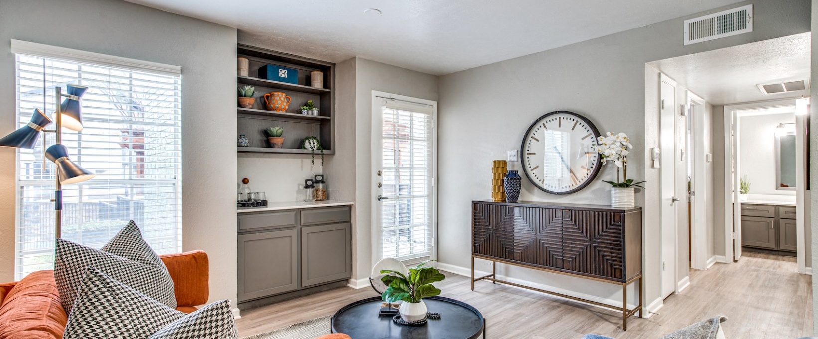 a living room with a couch, coffee table and a clock at The Richmond