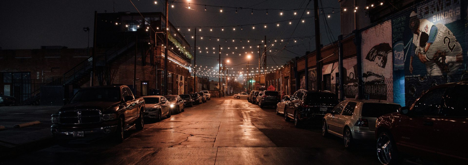 cars parked on side of the road during night time