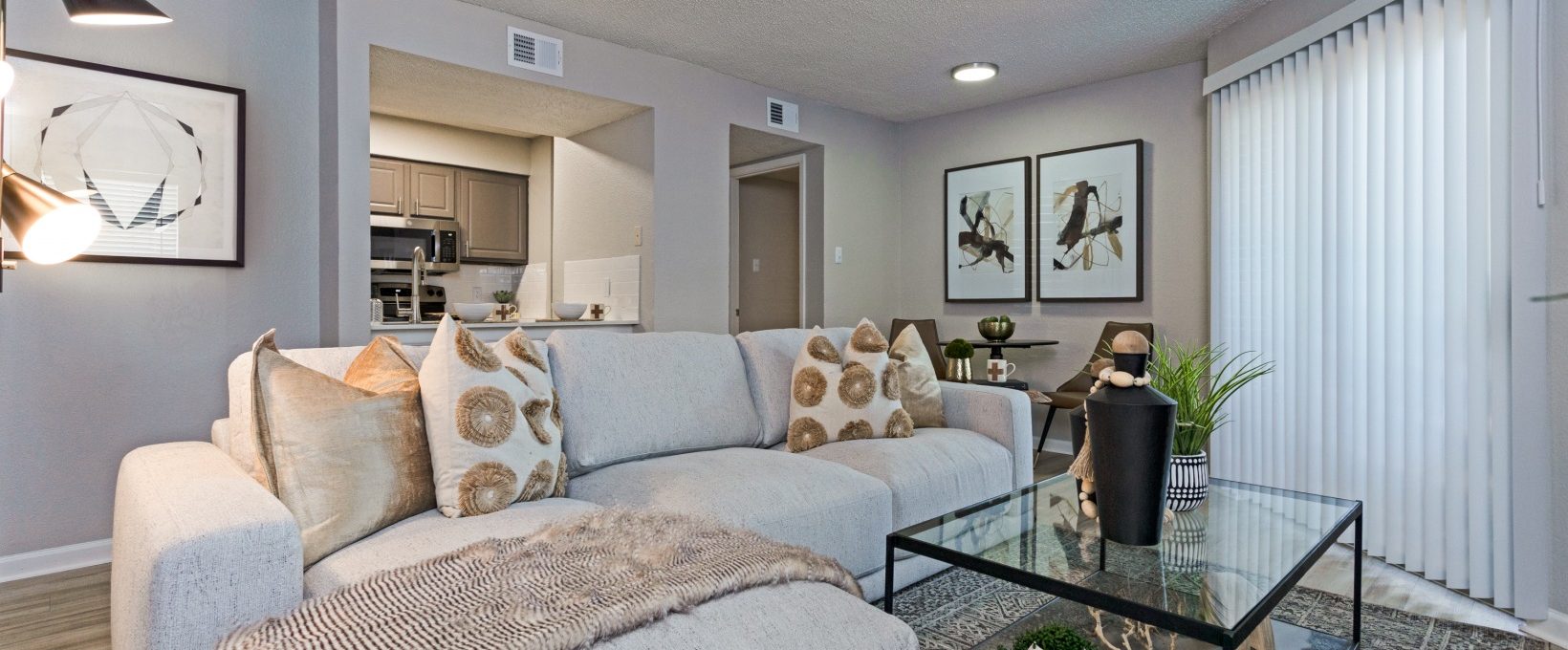 a living room with a couch, coffee table and television at The The Huxley