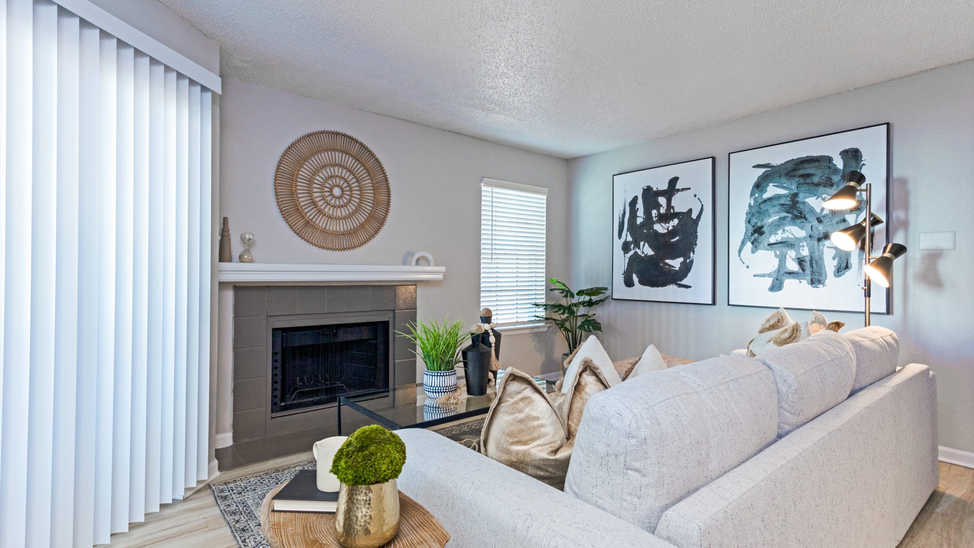 a living room with white furniture and a fireplace at The The Huxley