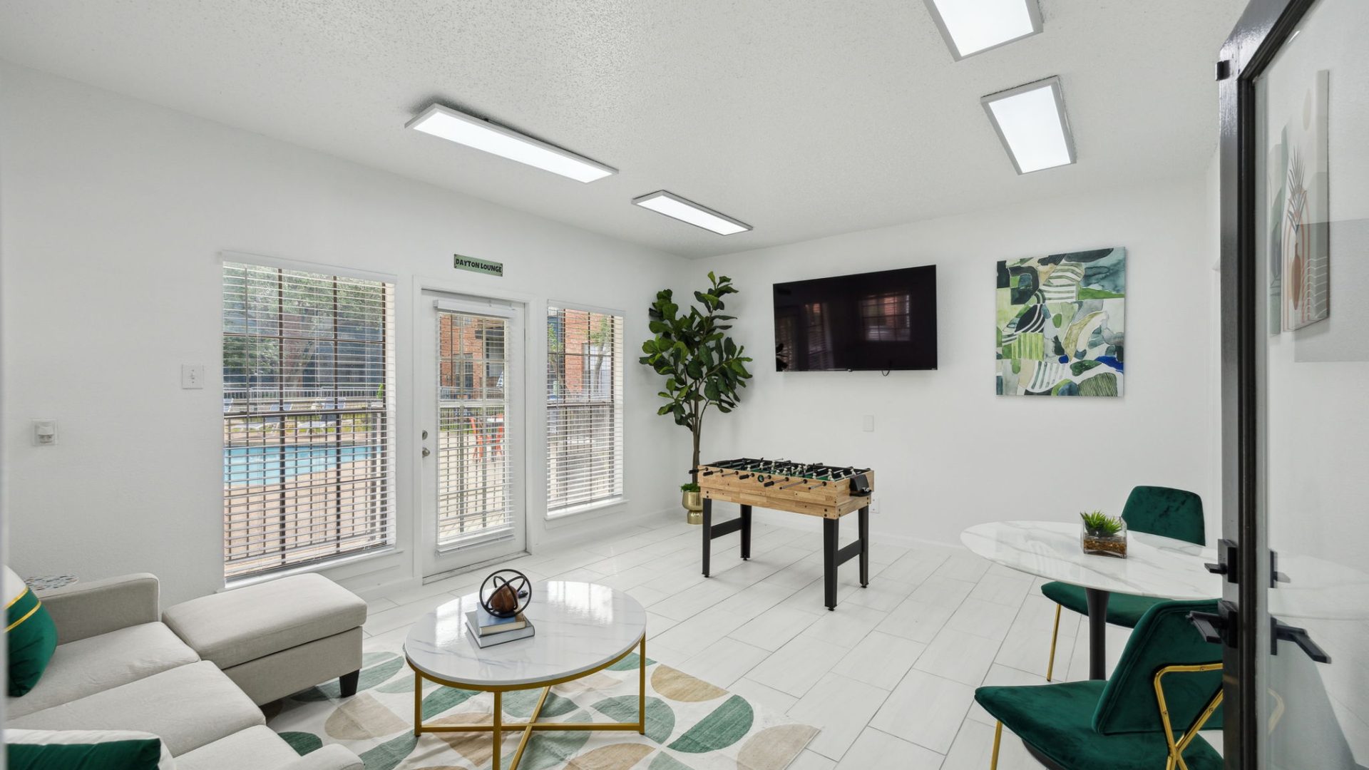 the living room has a pool table and a television at The  Dayton