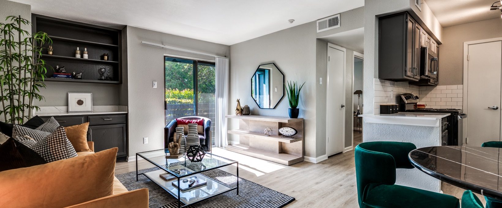 a living room with a couch, coffee table and chairs at The  Kace