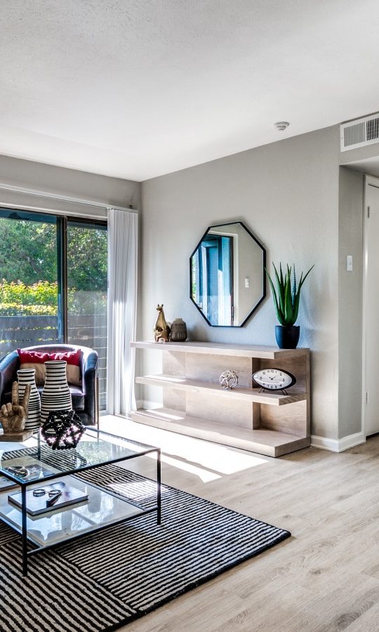 a living room with a couch, coffee table and chairs at The  Kace