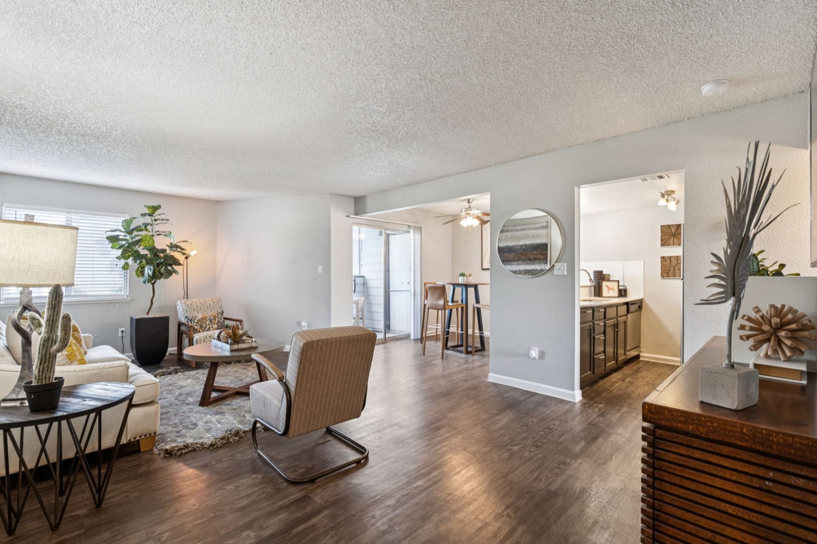 the living room has hardwood floors and a large window at The  Mark at 2600