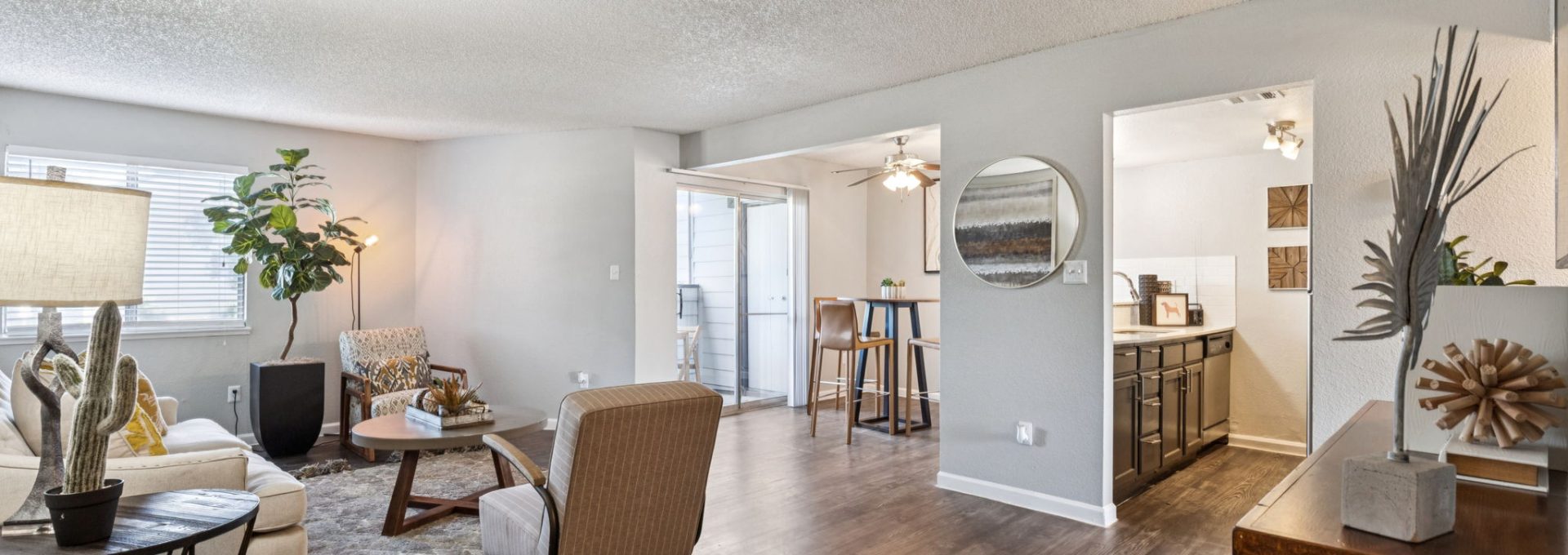 the living room has hardwood floors and a large window at The  Mark at 2600