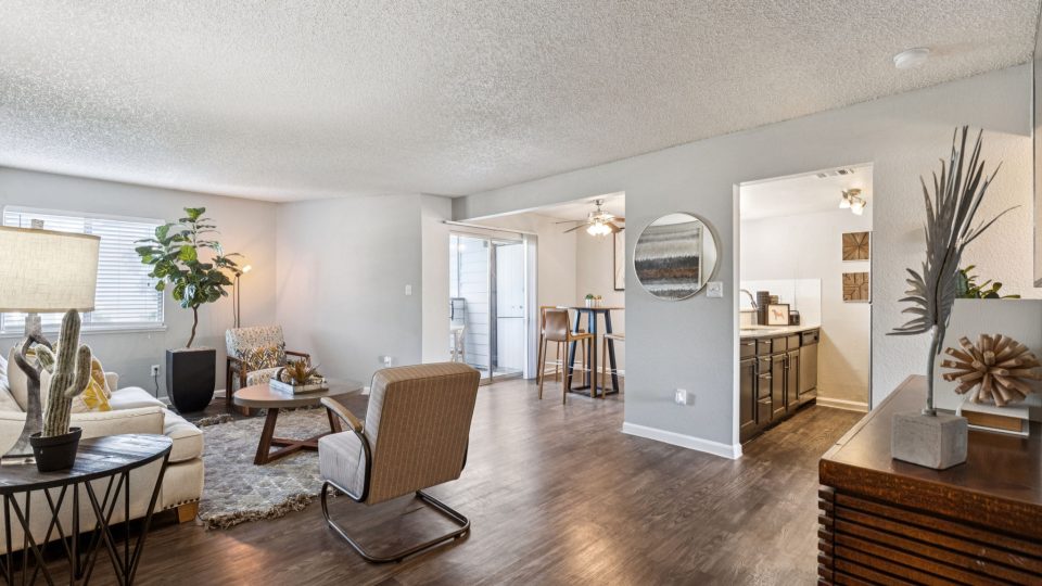 the living room has hardwood floors and a large window at The  Mark at 2600