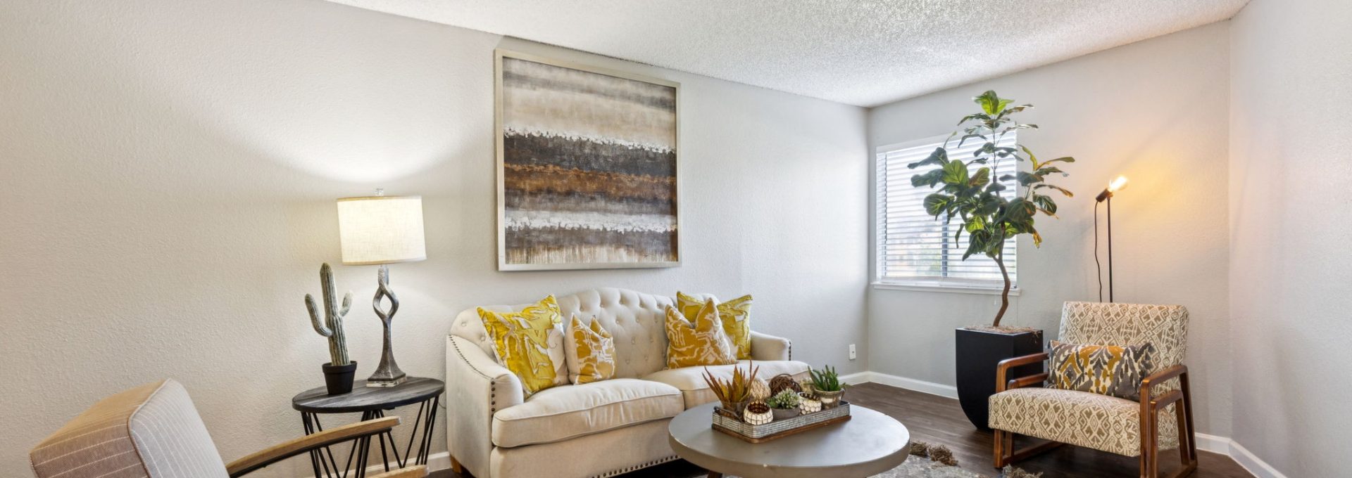 a living room with a couch, coffee table and chairs at The  Mark at 2600