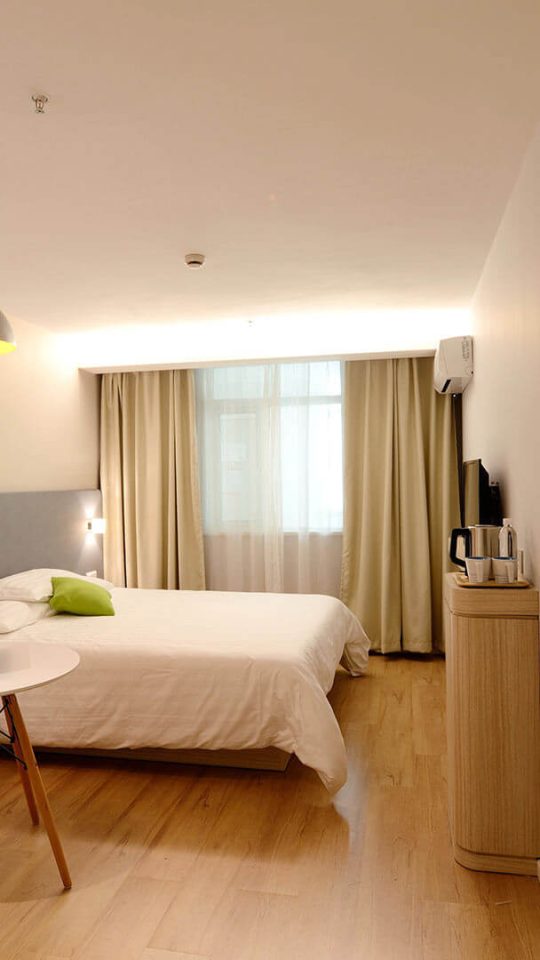 a hotel room with two beds and a desk at The  Republic East & West