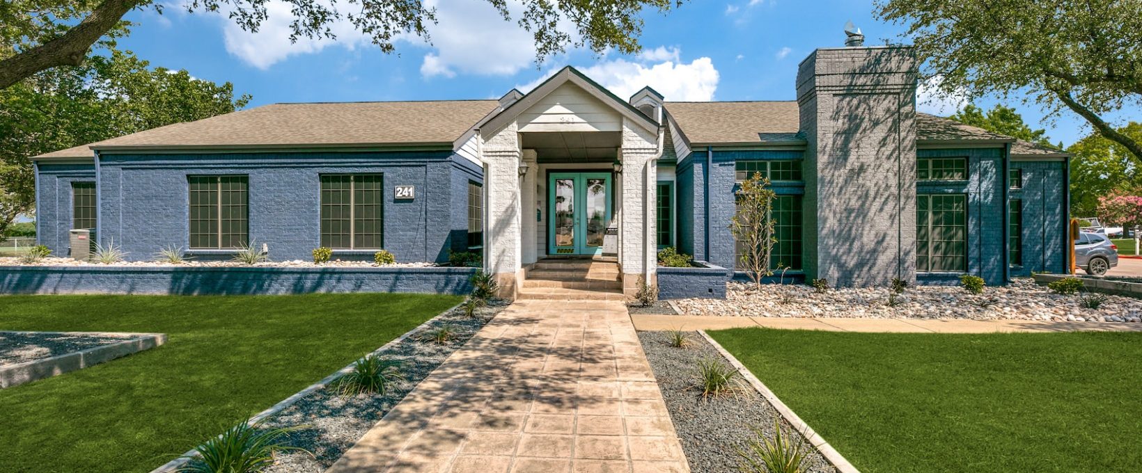 a home with a large front yard and grass at The  Republic East & West