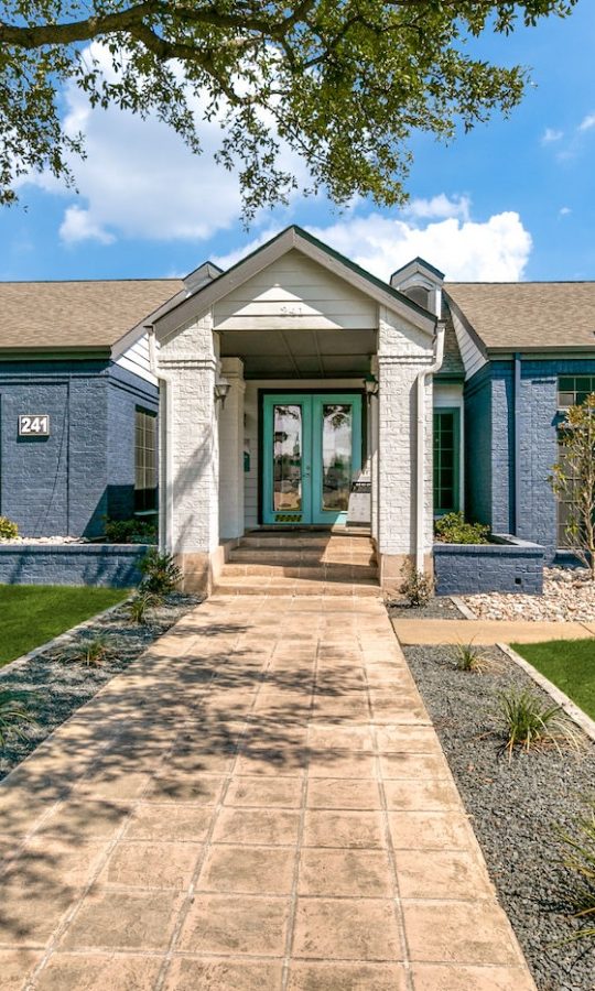 a home with a large front yard and grass at The  Republic East & West