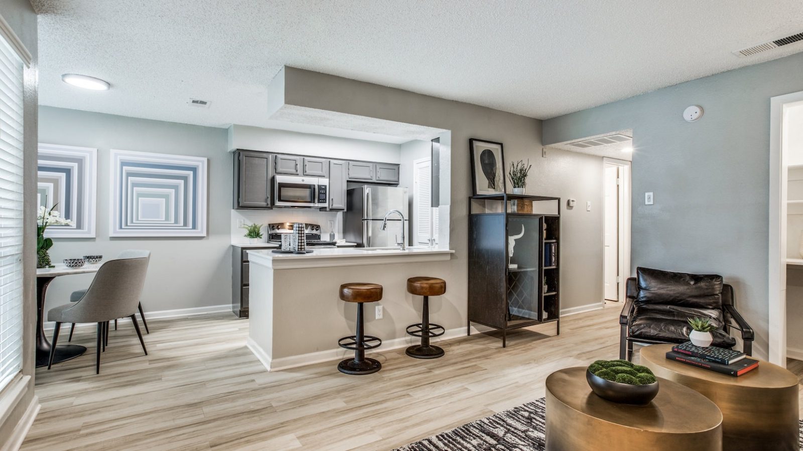 the living room and kitchen area of a new apartment at The Republic East & West