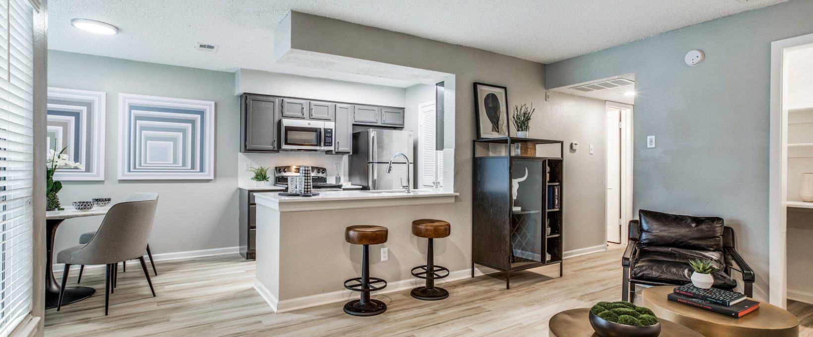 the living room and kitchen area of a new apartment at The  Republic East & West