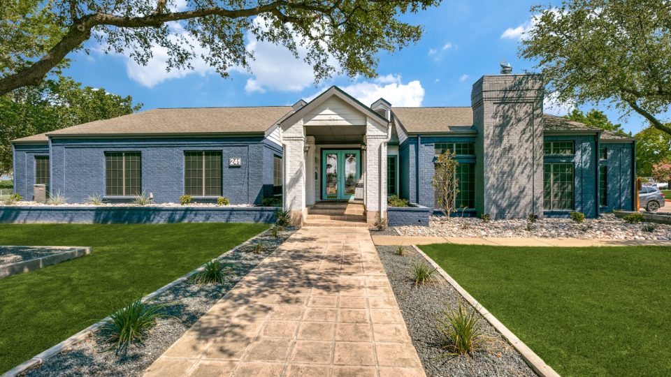 a home with a large front yard and grass at The  Republic East & West