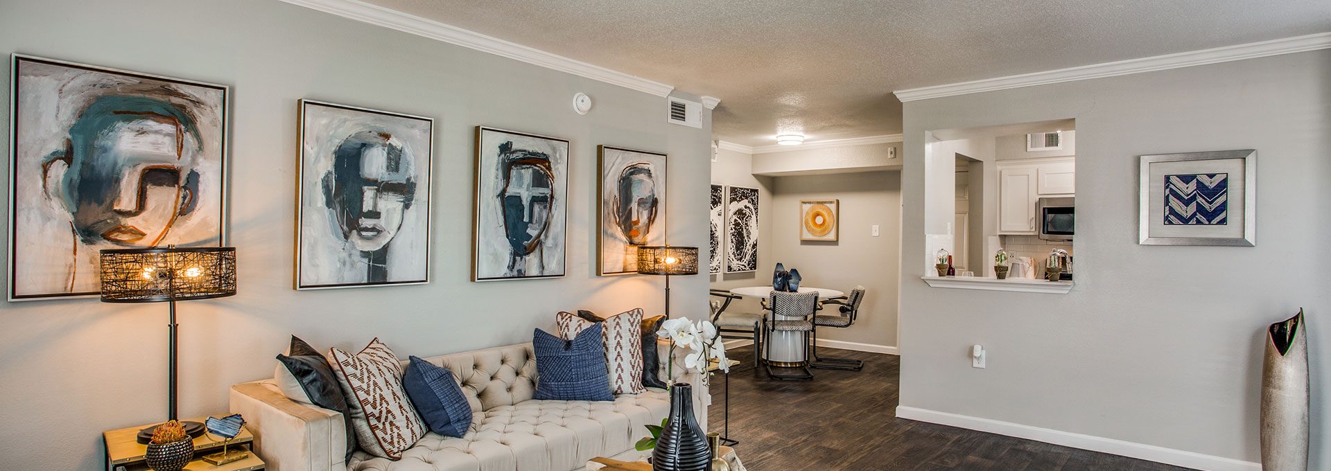 the living room has a large couch and a painting on the wall at The WESTON