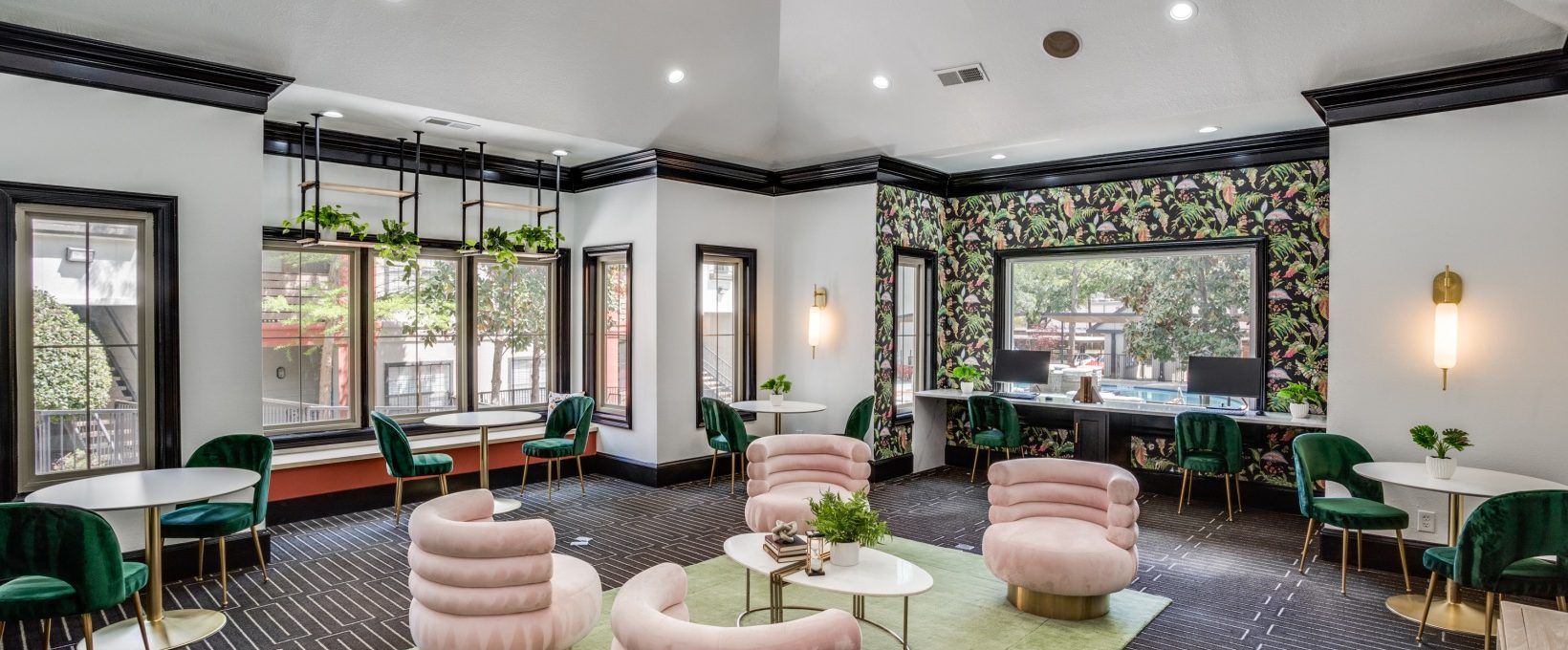 the lobby of a hotel with green chairs and pink walls at The  Lana