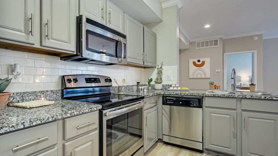 a kitchen with stainless steel appliances and granite counter tops at The  Lana