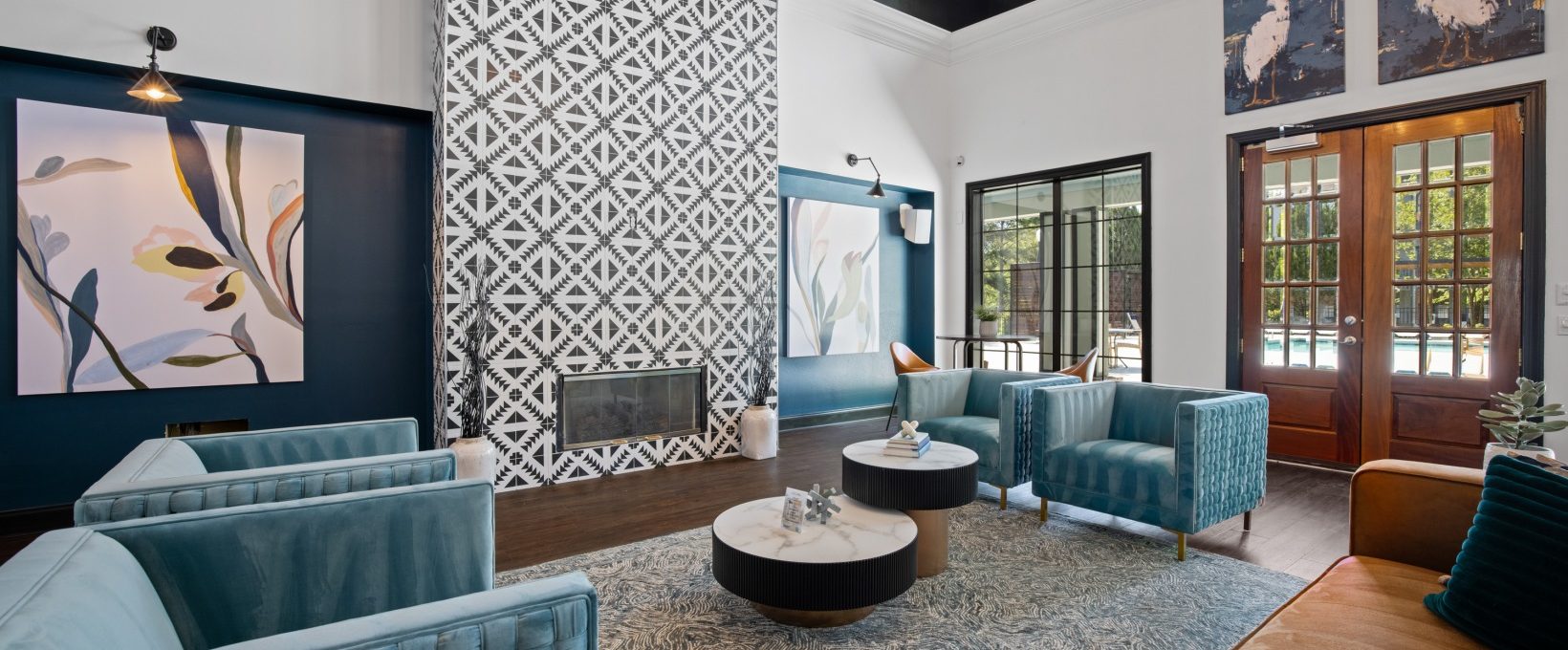 the living room features blue couches and a fireplace at The Landon