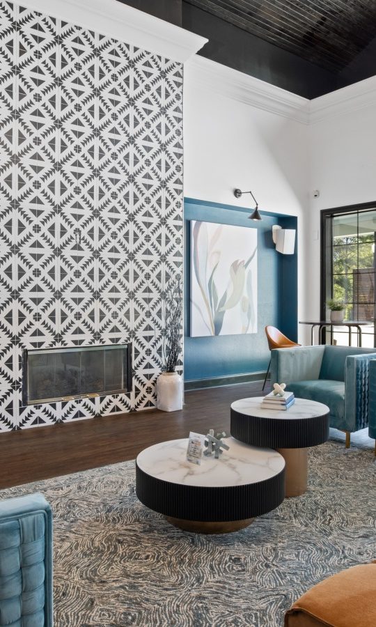 the living room features blue couches and a fireplace at The Landon