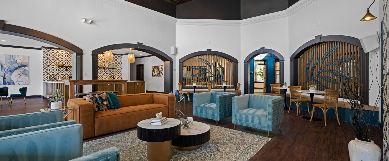 the lobby of a hotel with blue couches and chairs at The Landon
