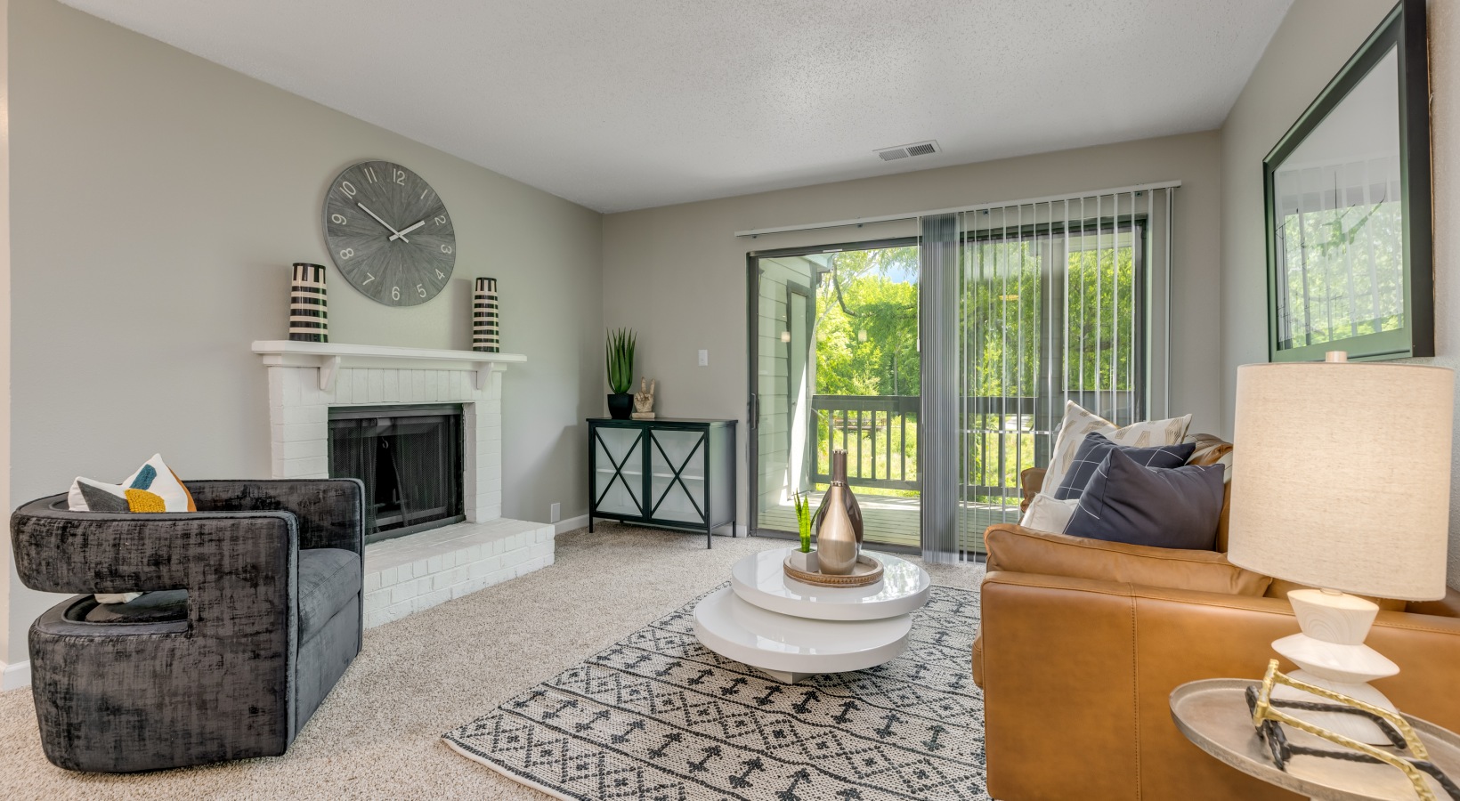 a living room with a fireplace and a couch at The Landon