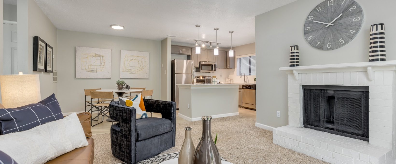 a living room with a fireplace and a couch at The Landon