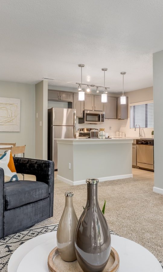 a living room with a fireplace and a couch at The Landon
