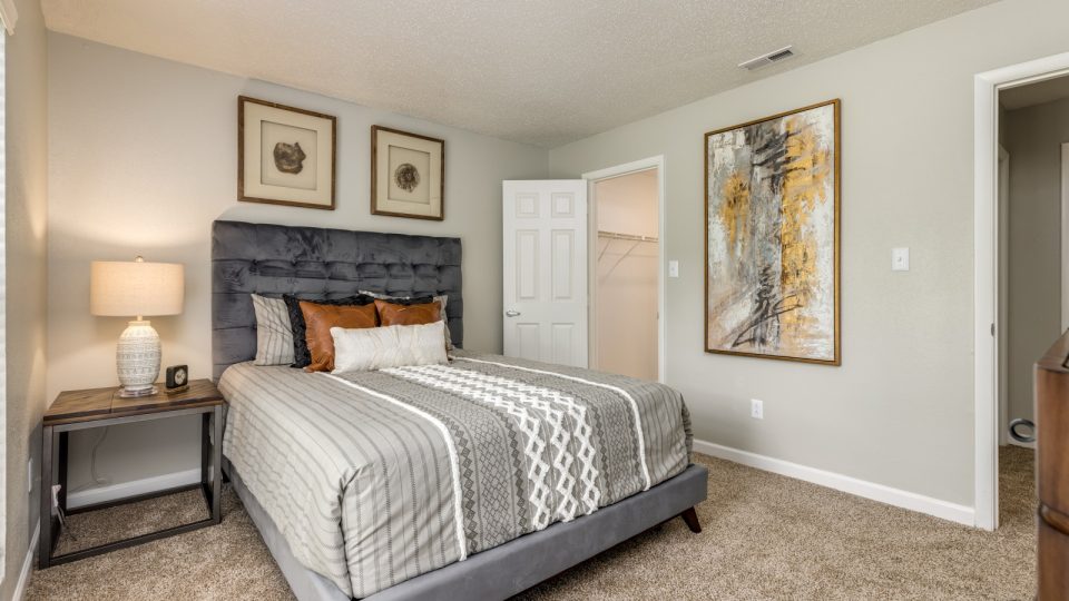 a bedroom with a bed, dresser and nightstand at The Landon