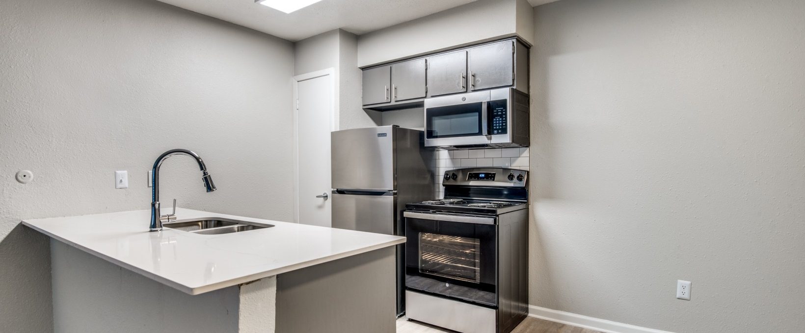 a kitchen with stainless steel appliances and a microwave at The Palmilla