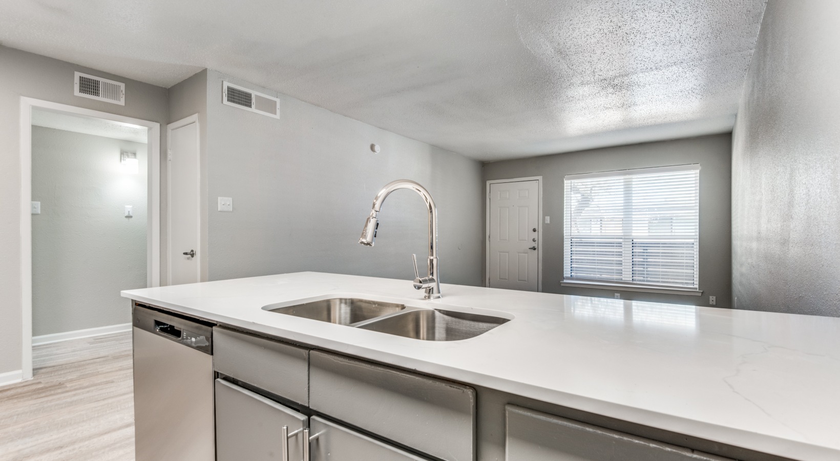 a kitchen with stainless steel appliances and white cabinets at The Palmilla