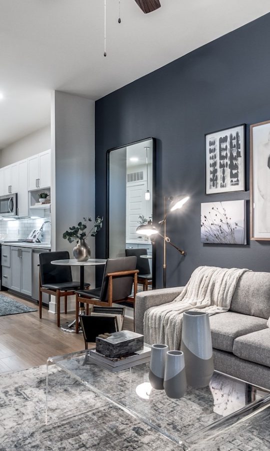a living room with blue walls and gray furniture at The Cedar at  Branch