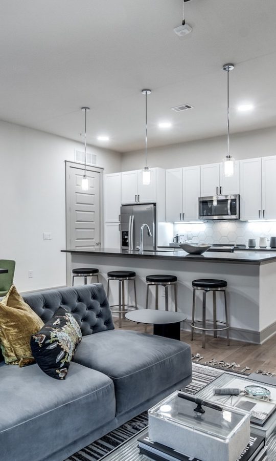 a living room and kitchen area with a couch and coffee table at The Cedar at  Branch