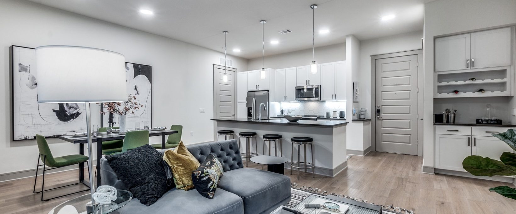 a living room and kitchen area with a couch and coffee table at The Cedar at  Branch