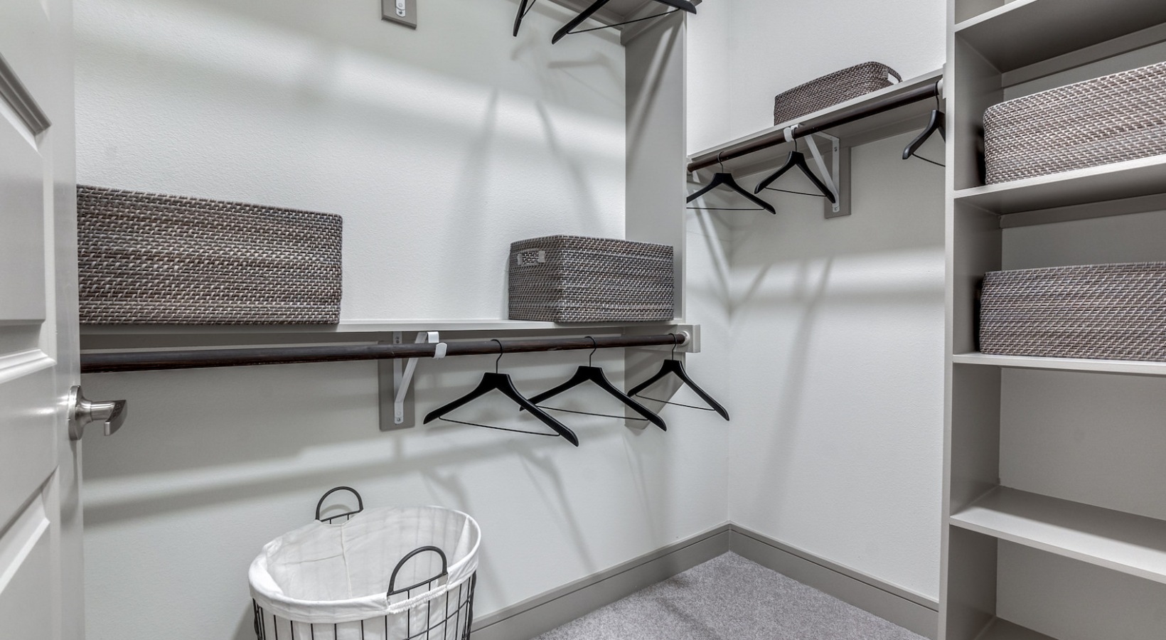 a walk in closet with shelves and baskets at The Cedar at  Branch
