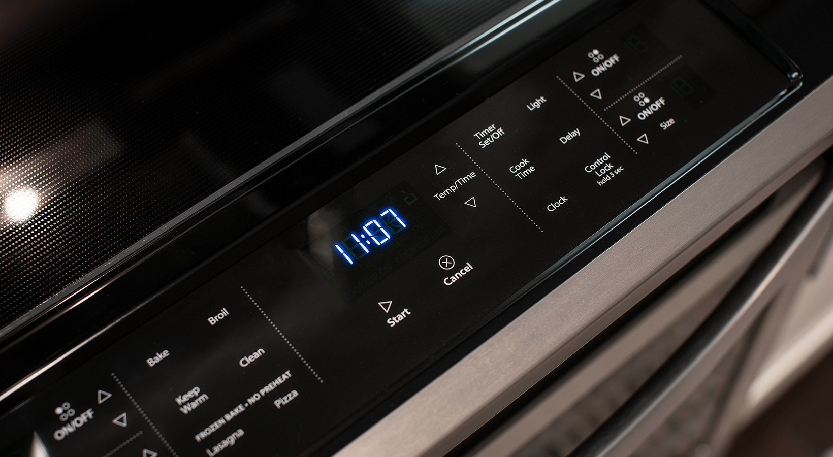 a close up of a digital clock on a stove at The Cedar at  Branch