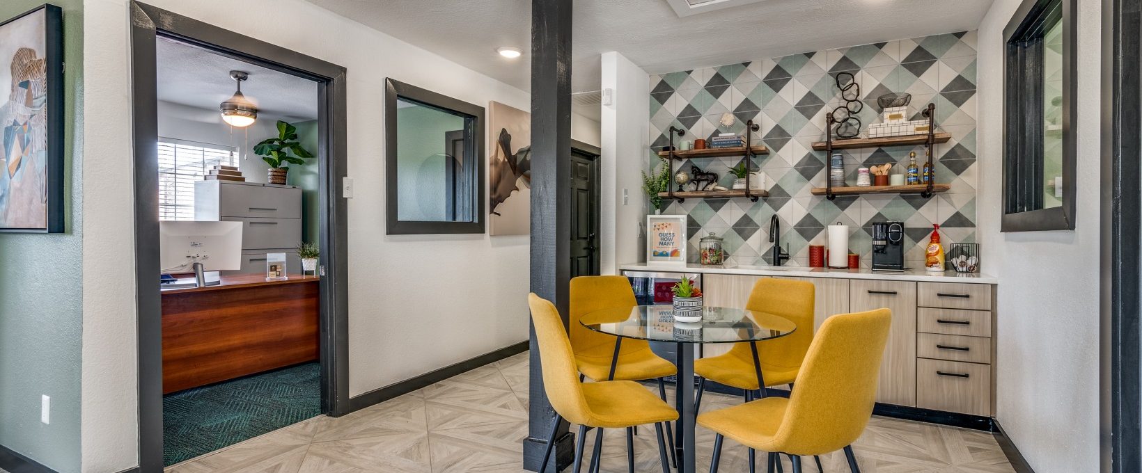 a kitchen with yellow chairs and a table at The Wilder