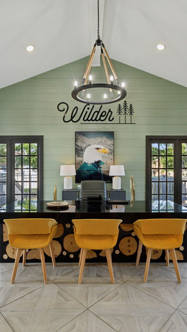 the dining room has a large table and chairs at The Wilder