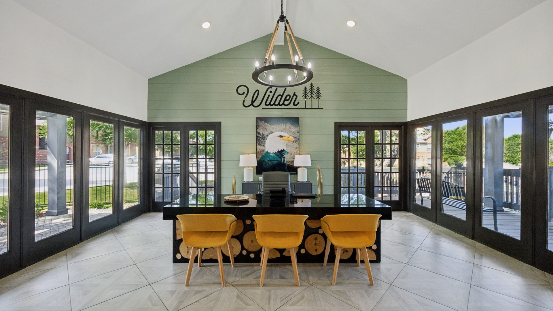 the dining room has a large table and chairs at The Wilder