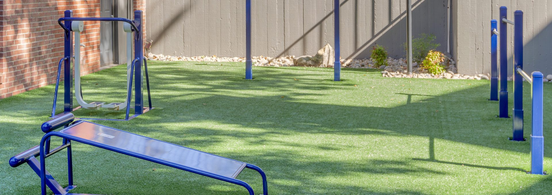 a gym set up in a backyard with artificial grass at The  Jaxon
