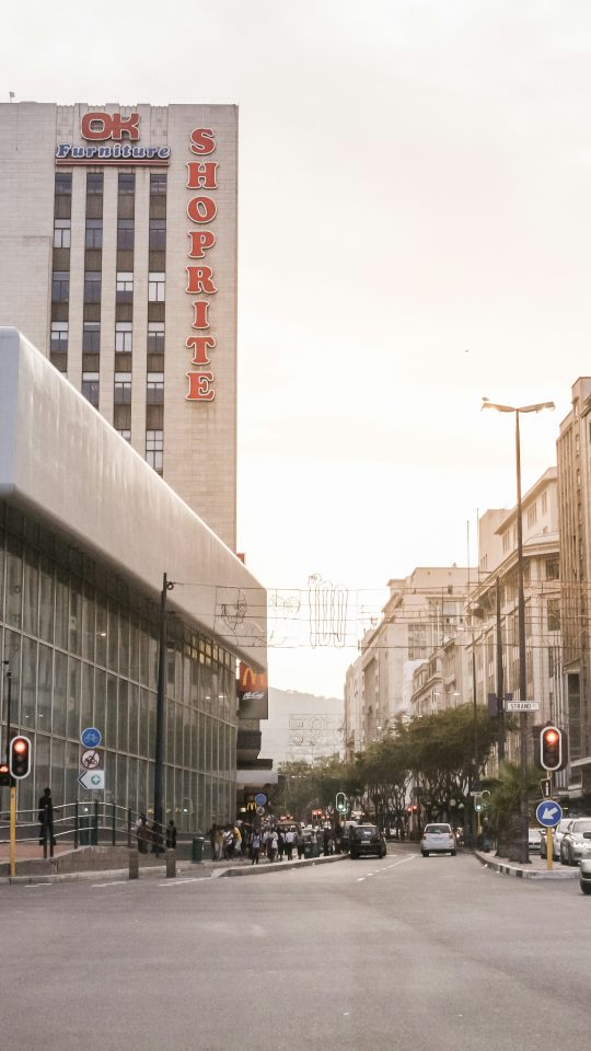 vehicles on street between buildings