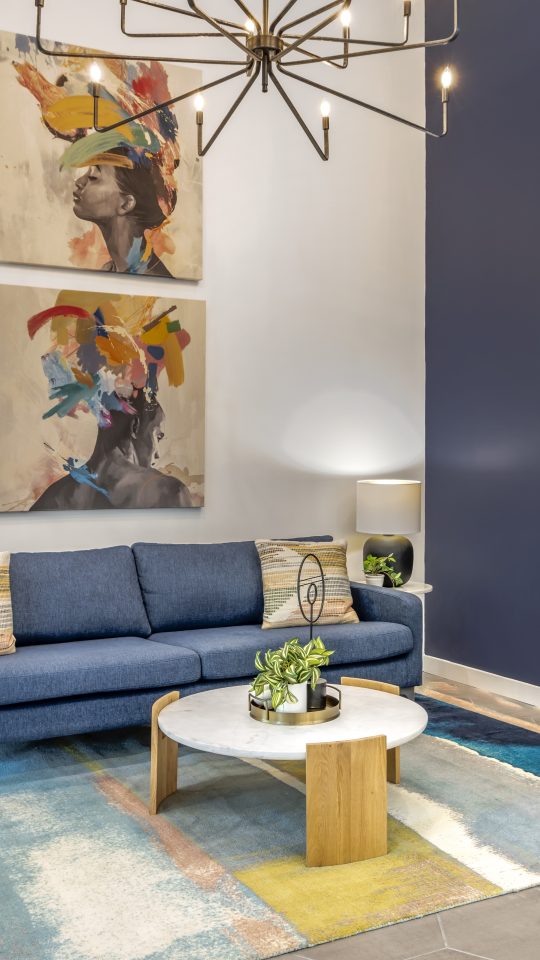 a blue couch and coffee table in a living room at The  Jaxon