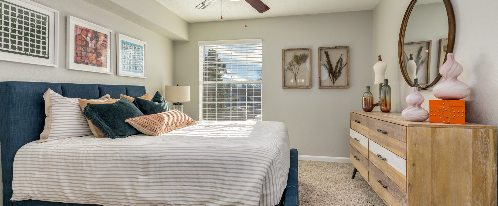 a bedroom with a ceiling fan and a bed at The Winslow